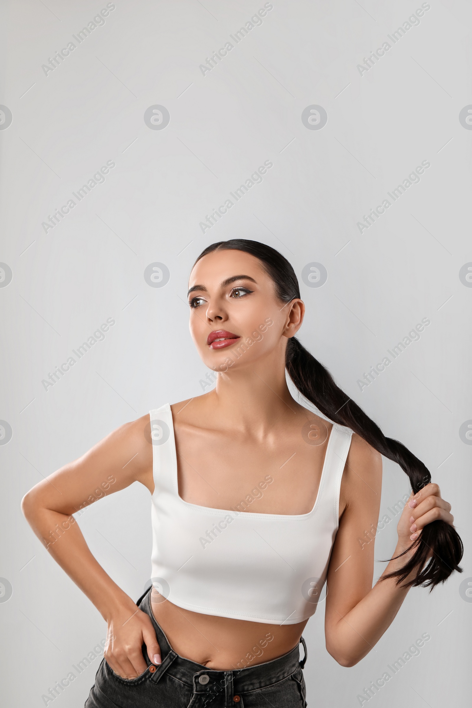 Photo of Beautiful woman wearing makeup on light grey background