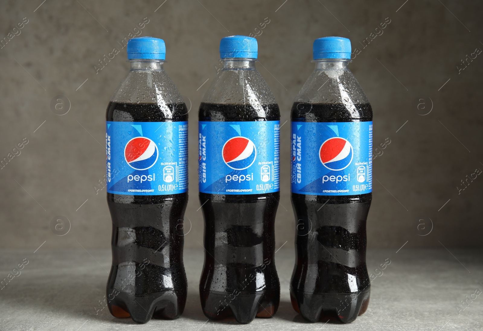 Photo of MYKOLAIV, UKRAINE - FEBRUARY 9, 2021: Bottles of Pepsi on grey table