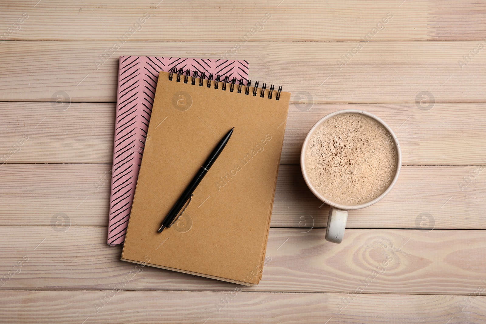 Photo of Flat lay composition with office stationery and cup of coffee on wooden table