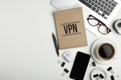 Image of Notebook with acronym VPN and space for text on white table, flat lay. Secure network connection