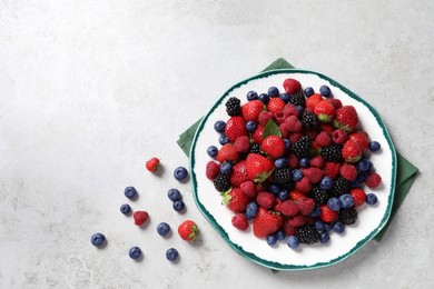 Photo of Different fresh ripe berries on light grey table, flat lay. Space for text