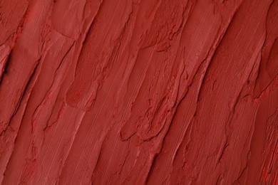Photo of Texture of bright lipstick as background, top view