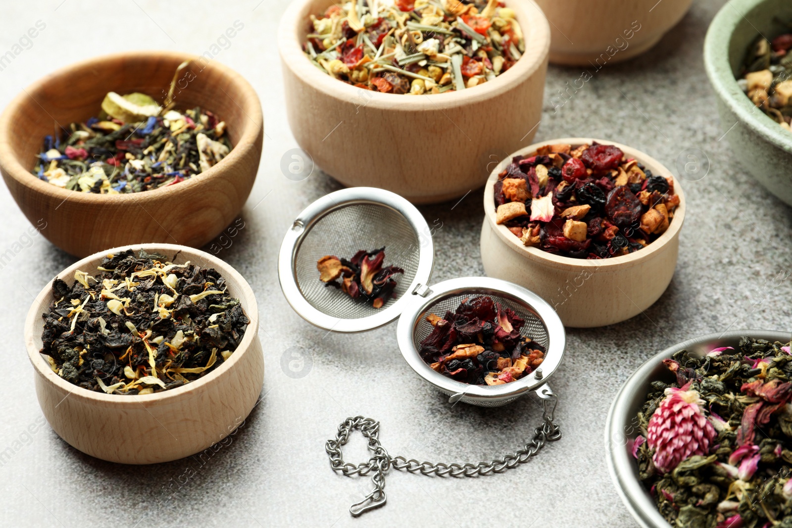 Photo of Many different herbal teas on grey table