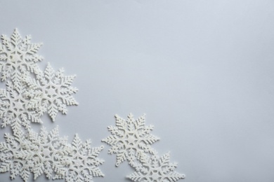 Beautiful snowflakes on white background, flat lay. Space for text