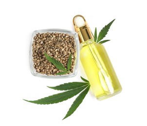 Photo of Bottle of hemp oil, leaves and seeds on white background, top view