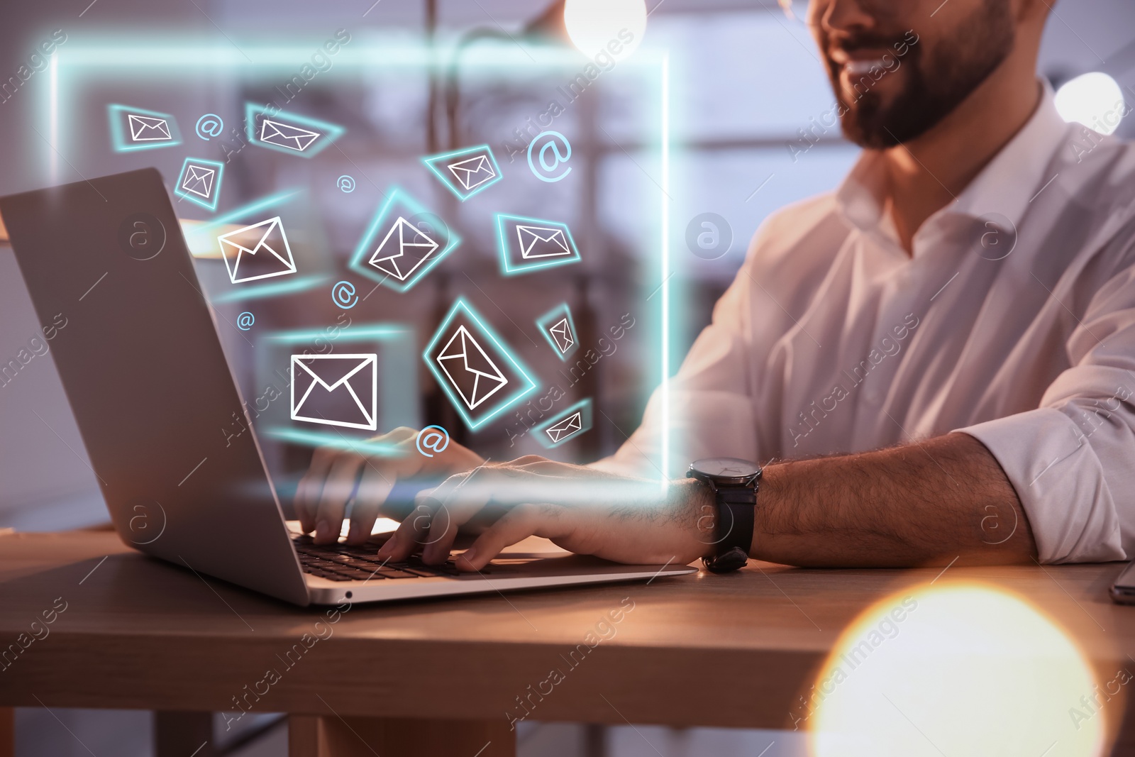 Image of Businessman sending emails at table indoors, closeup