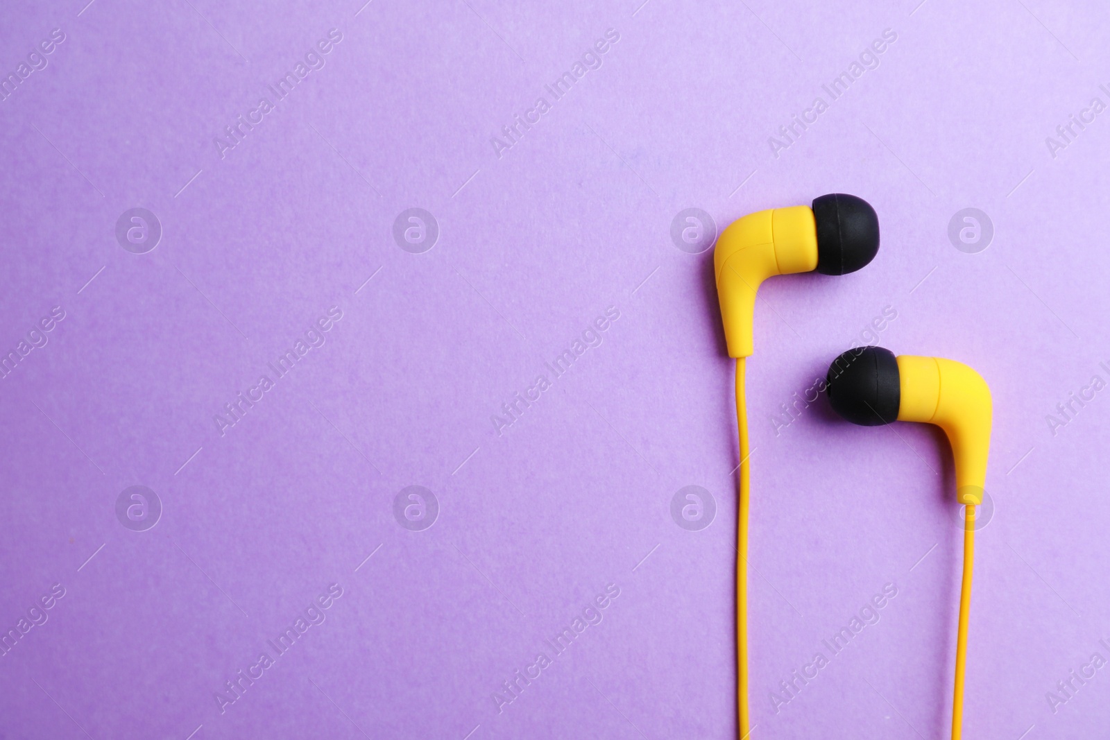 Photo of Stylish headphones on color background, top view. Space for text