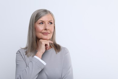 Portrait of beautiful senior woman on white background. Space for text