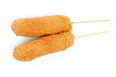 Photo of Delicious deep fried corn dogs isolated on white, top view