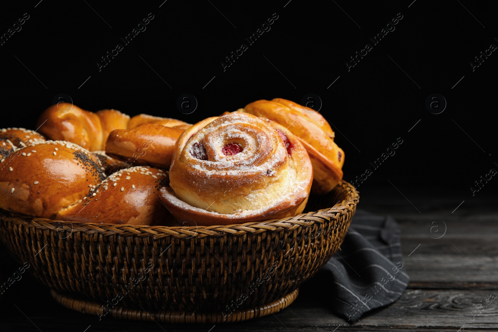 Photo of Different delicious fresh pastries on dark wooden table