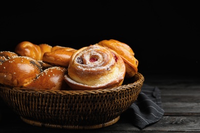 Different delicious fresh pastries on dark wooden table