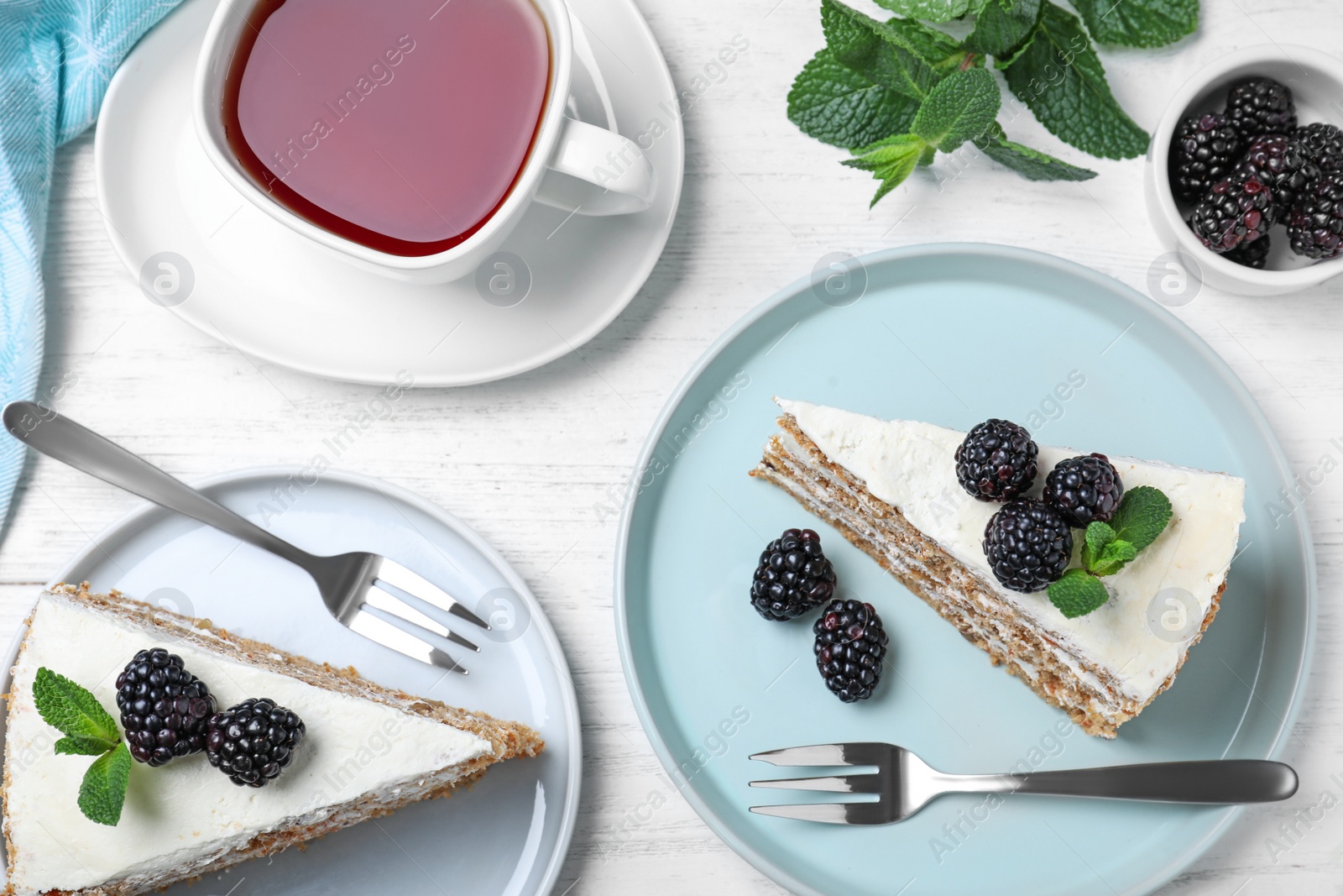 Photo of Tasty cake with berries on white wooden table, flat lay