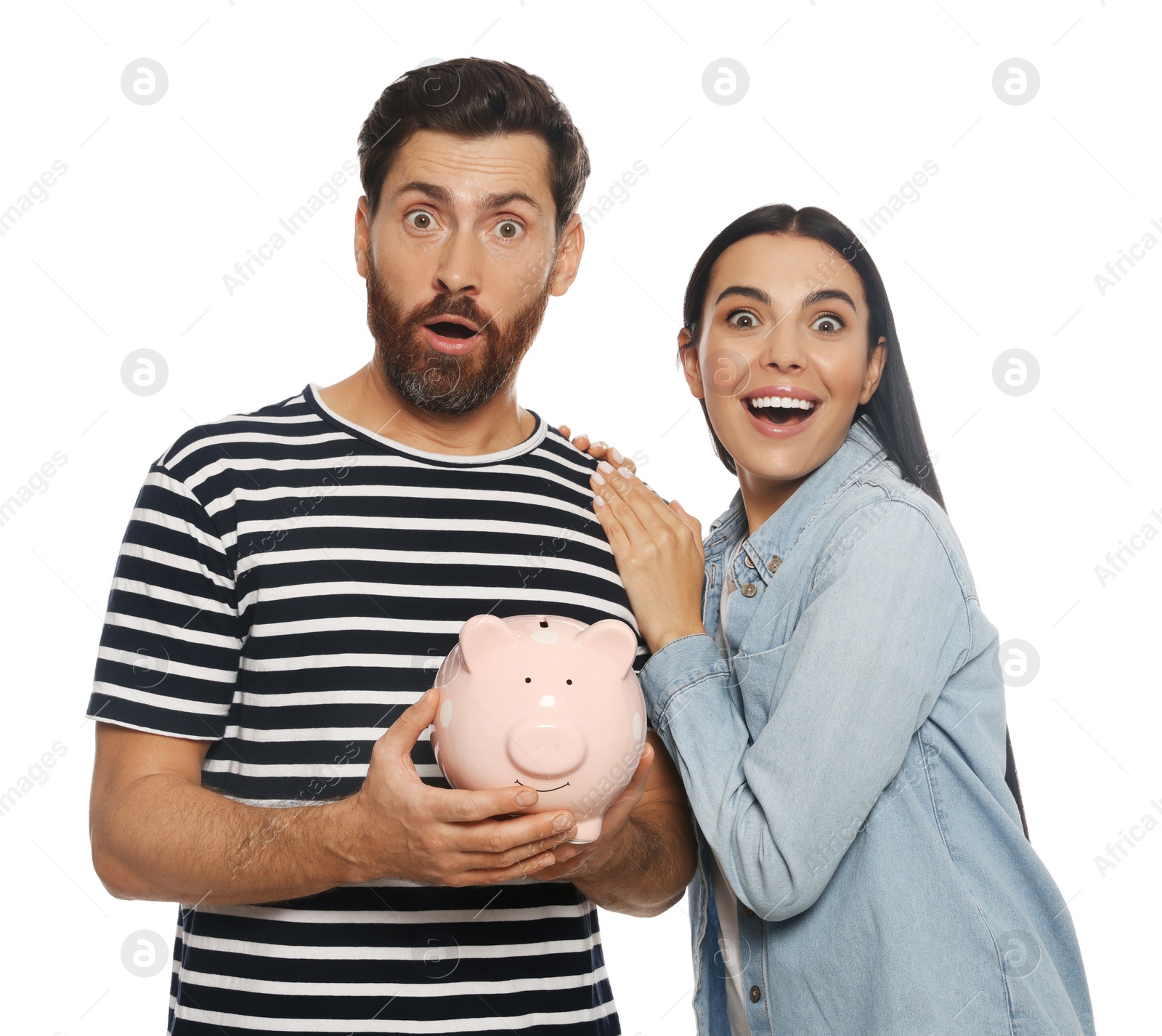 Photo of Happy couple with ceramic piggy bank on white background