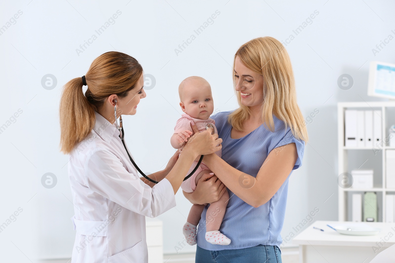 Photo of Woman with her baby visiting children's doctor in hospital