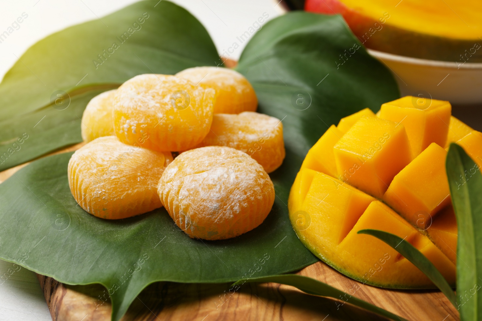 Photo of Composition with delicious mochi and mango on table. Traditional Japanese dessert