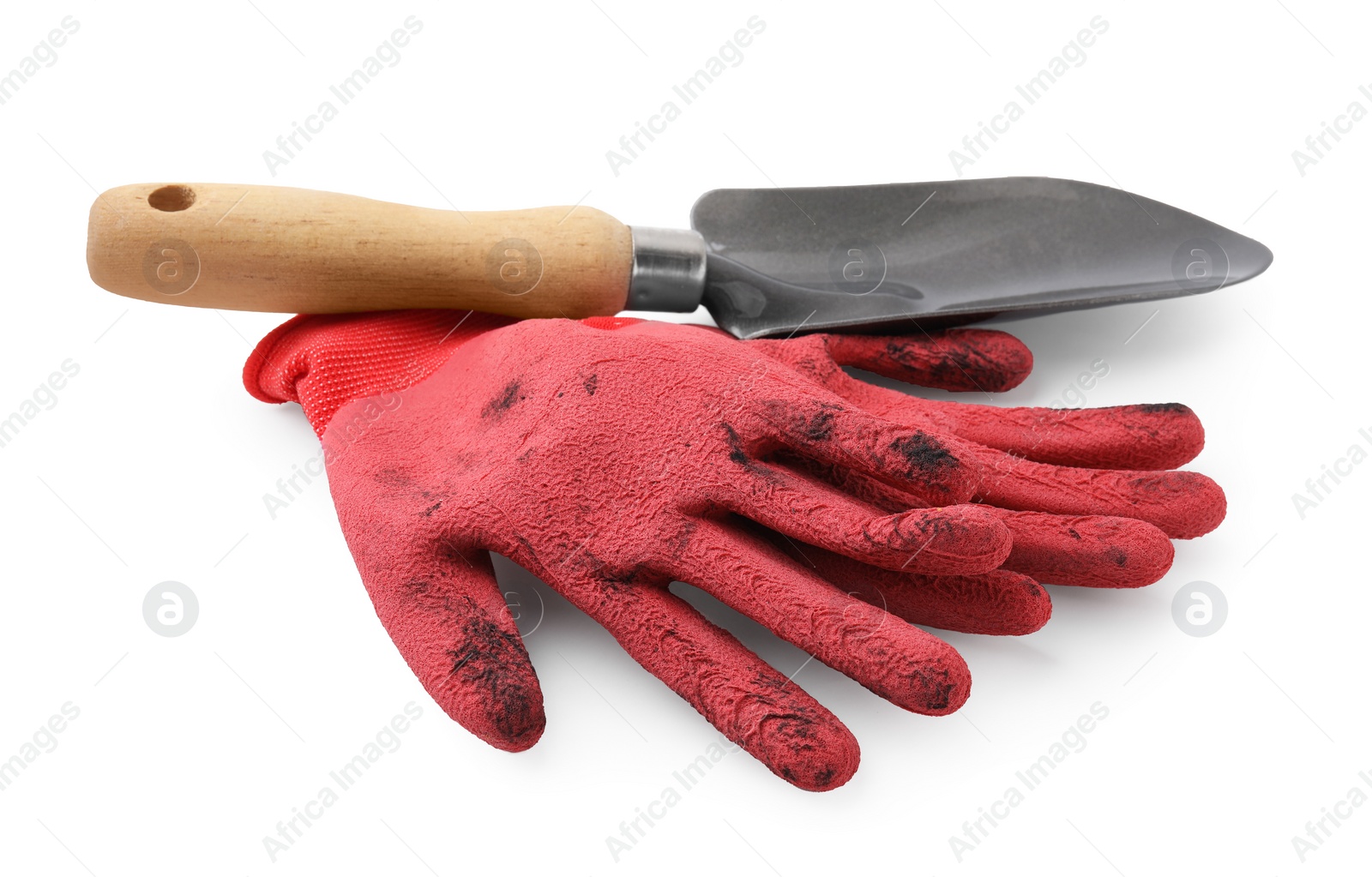 Photo of Pair of red gardening gloves and trowel isolated on white