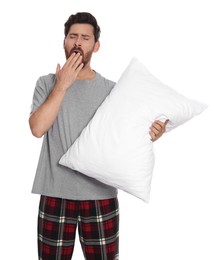 Photo of Tired man with pillow yawns on white background