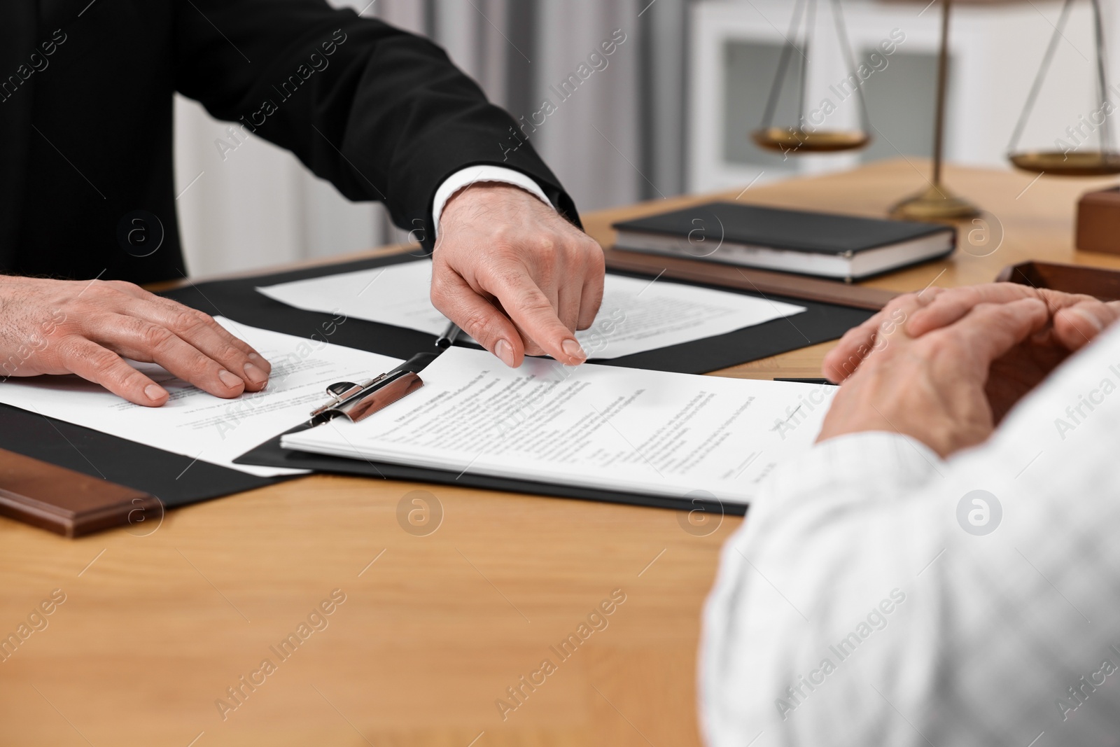 Photo of Senior man having meeting with lawyer in office, closeup