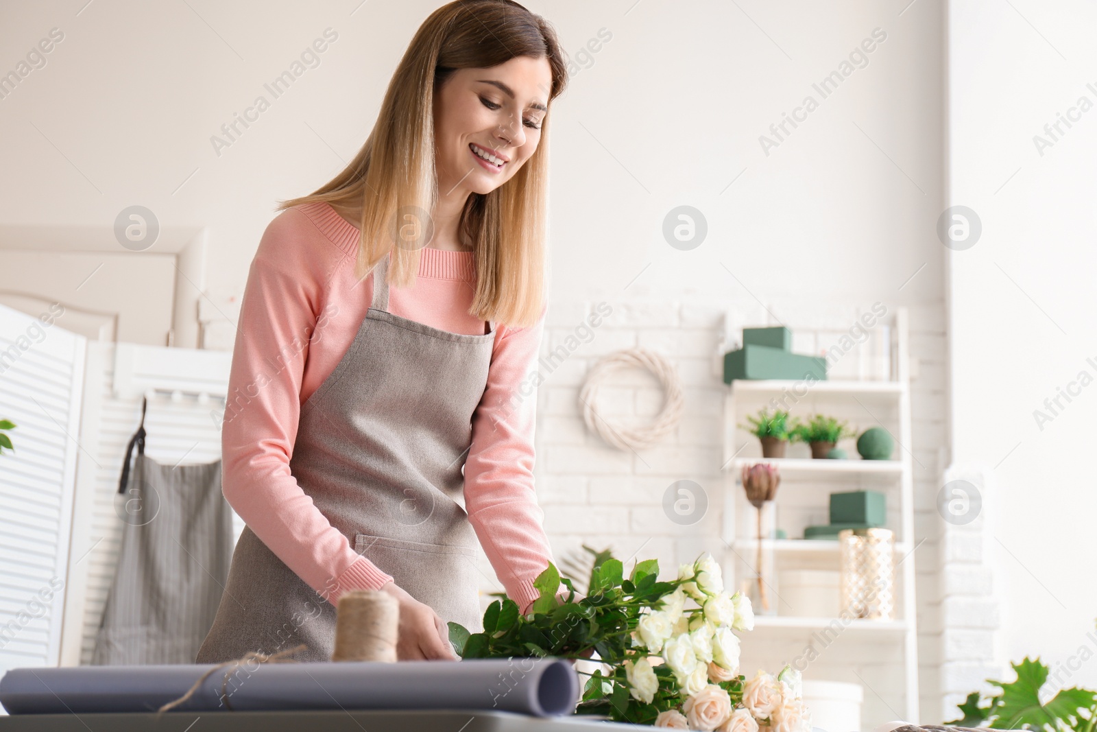 Photo of Female florist creating bouquet at workplace