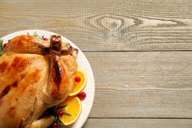 Delicious cooked turkey served on wooden table, top view with space for text. Thanksgiving Day celebration