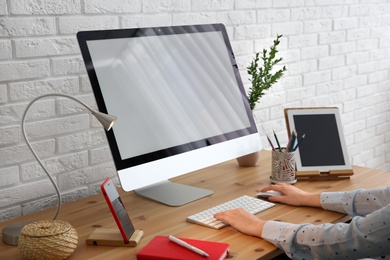 Photo of Young woman using modern computer at table, closeup