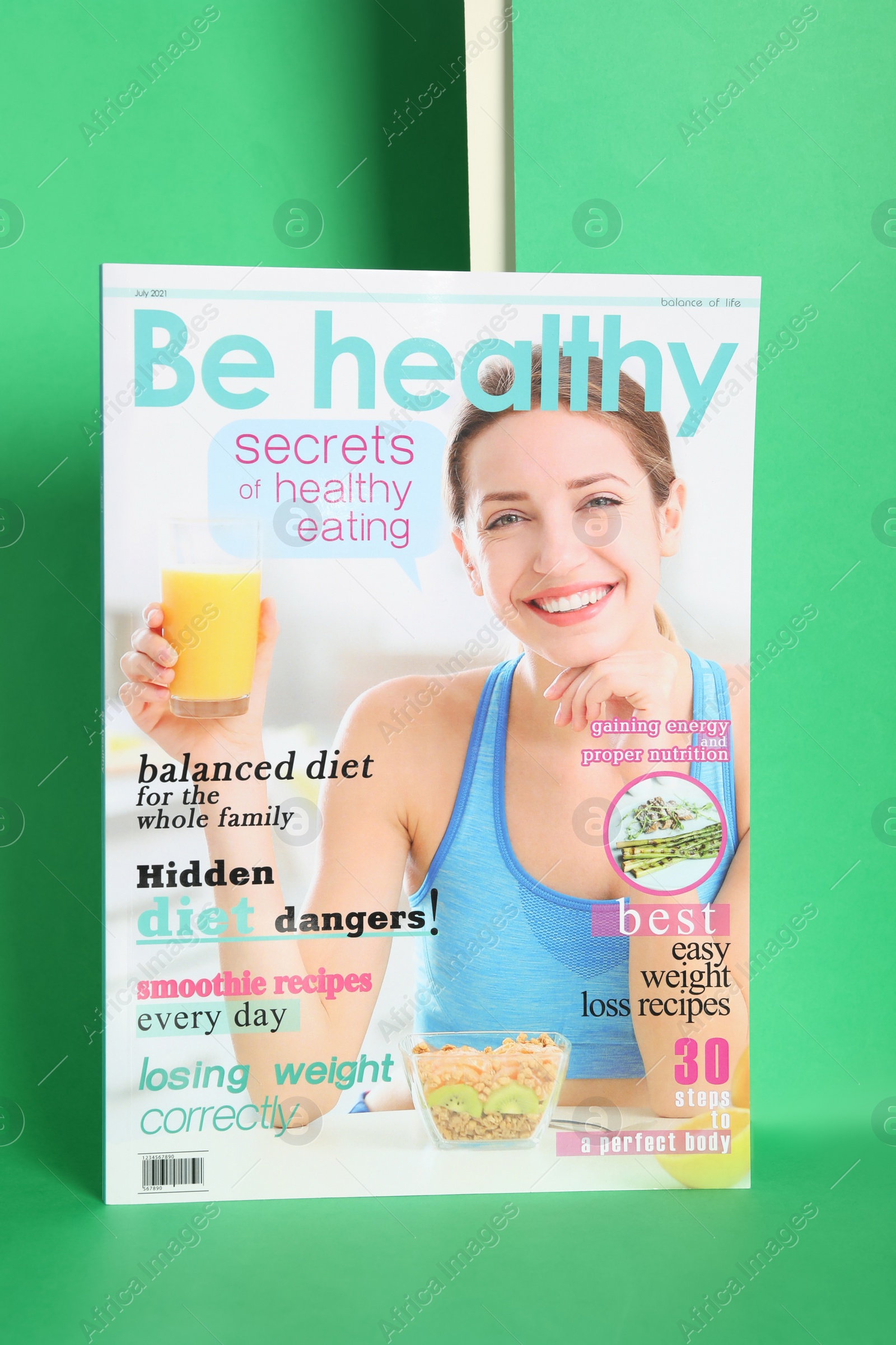 Photo of Modern healthy food magazine on green background