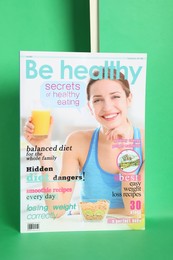 Modern healthy food magazine on green background