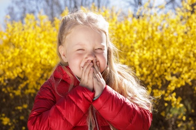 Photo of Little girl suffering from seasonal allergy outdoors
