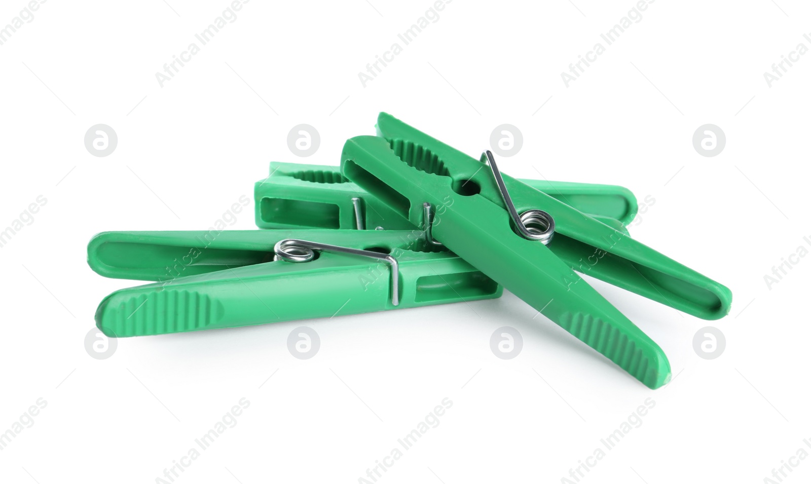 Photo of Bright green plastic clothespins on white background