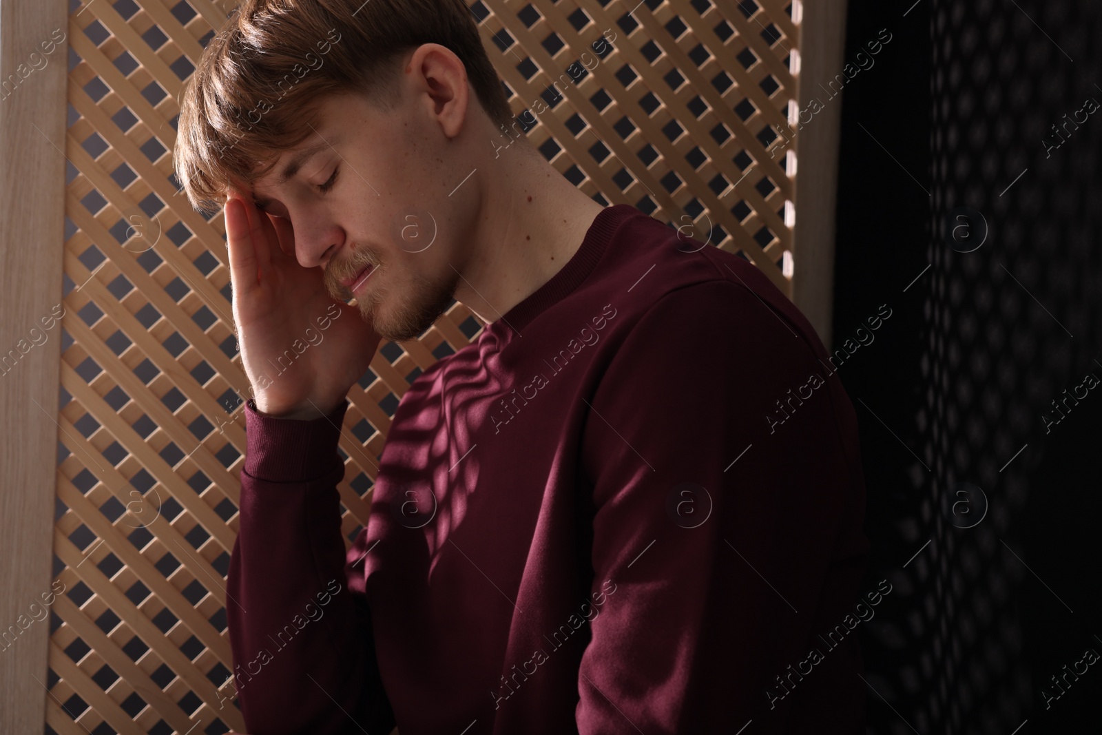 Photo of Upset young man during confession in church