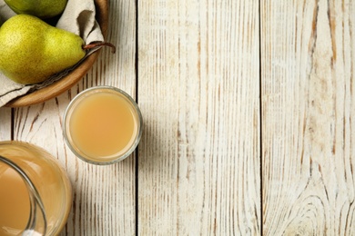 Tasty pear juice and fruits on white wooden table, flat lay. Space for text