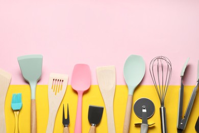 Photo of Different spatulas and other kitchen utensils on color background, flat lay. Space for text