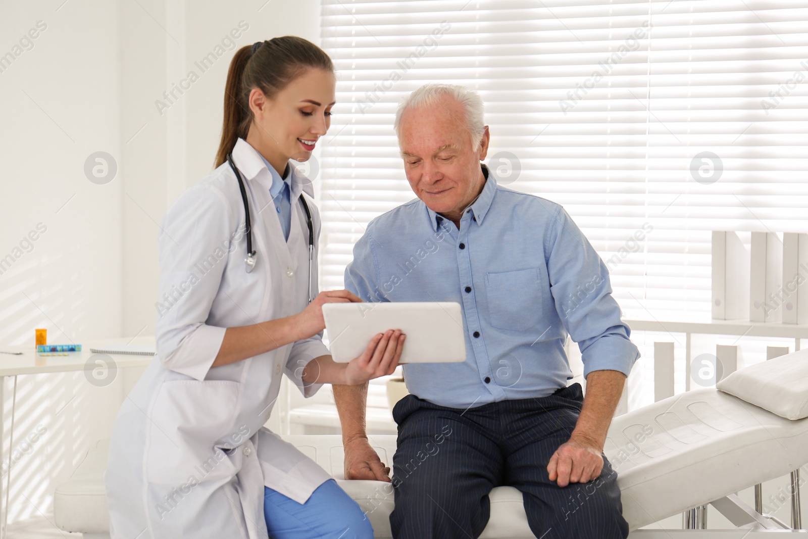 Photo of Senior man visiting doctor in modern office