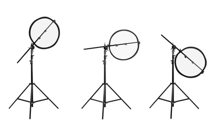 Set of tripods with reflectors on white background. Professional photographer's equipment