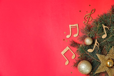 Photo of Flat lay composition with fir tree, Christmas decor and wooden music notes on color background. Space for text