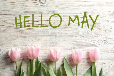 Image of Hello May. Beautiful spring tulips on wooden background, flat lay