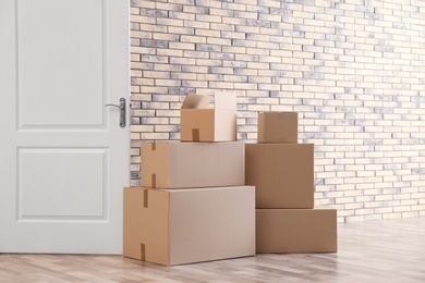 Photo of Pile of moving boxes in empty room