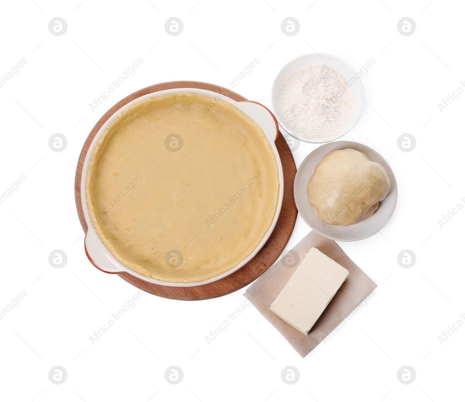 Photo of Pie tin with fresh dough and ingredients isolated on white, top view. Making quiche