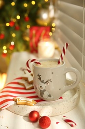 Photo of Composition with cup of hot drink on windowsill