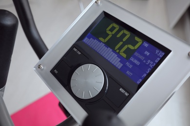 Photo of Control panel of modern elliptical machine cross trainer on blurred background