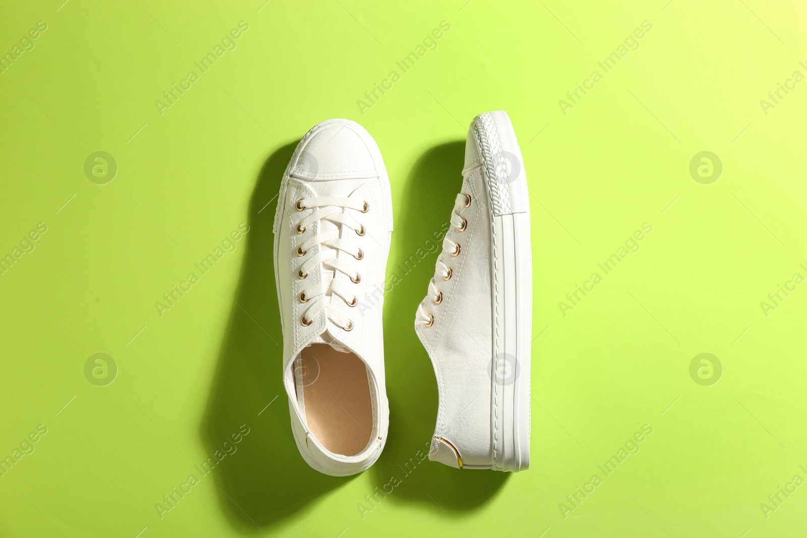 Photo of Pair of stylish sneakers on color background, flat lay