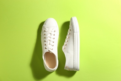 Pair of stylish sneakers on color background, flat lay