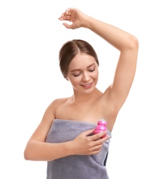 Young woman applying deodorant to armpit on white background