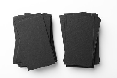 Photo of Blank black business cards on white background, top view. Mockup for design