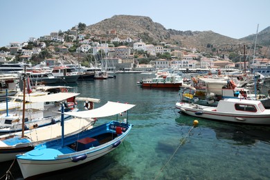 Beautiful view of coastal city with different boats on sunny day