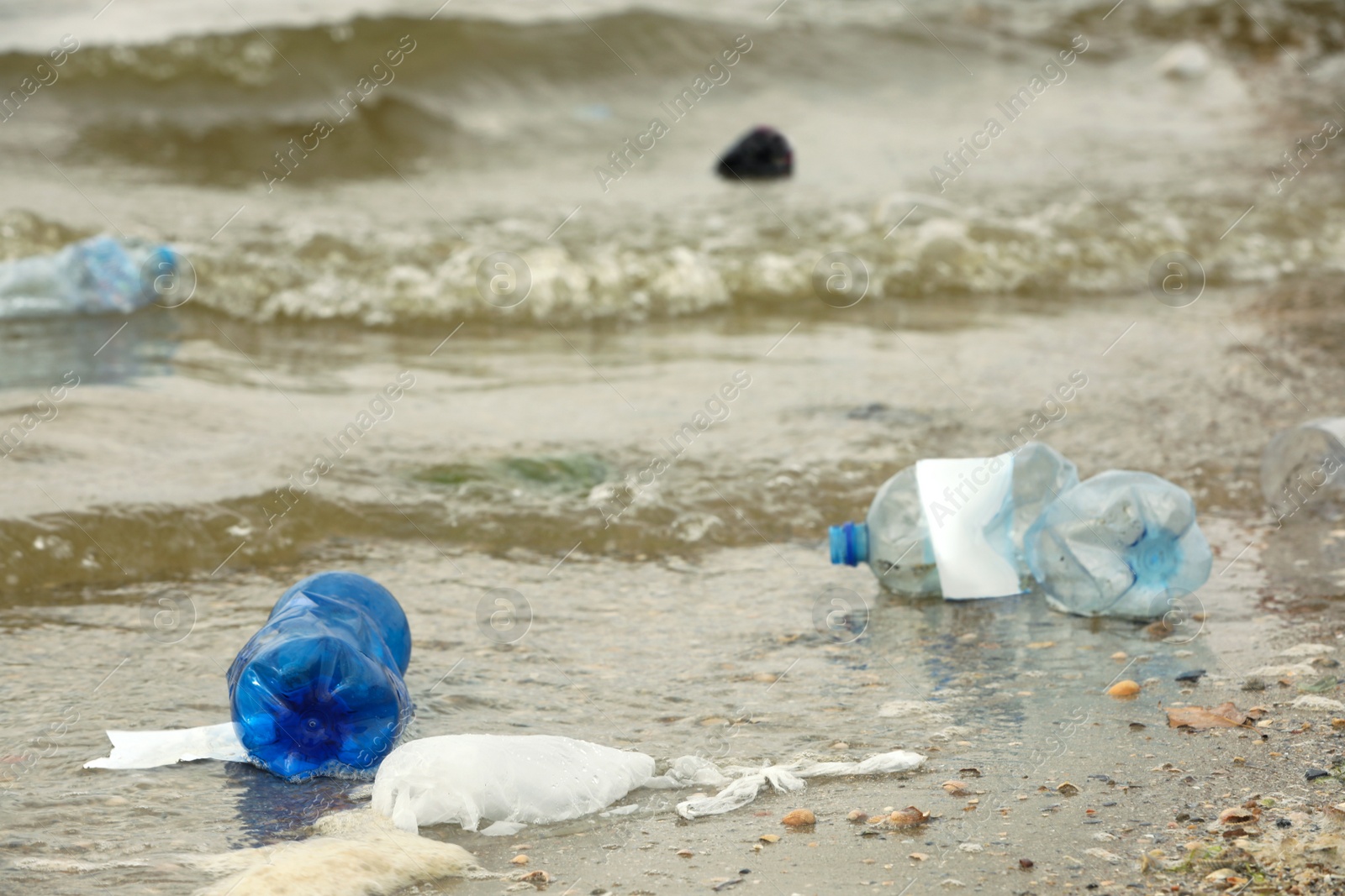 Photo of Beach polluted with plastic garbage. Ecological problem