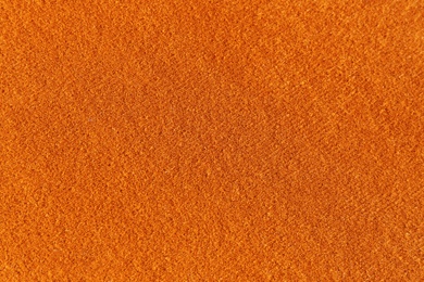 Photo of Orange textured surface as background, closeup view