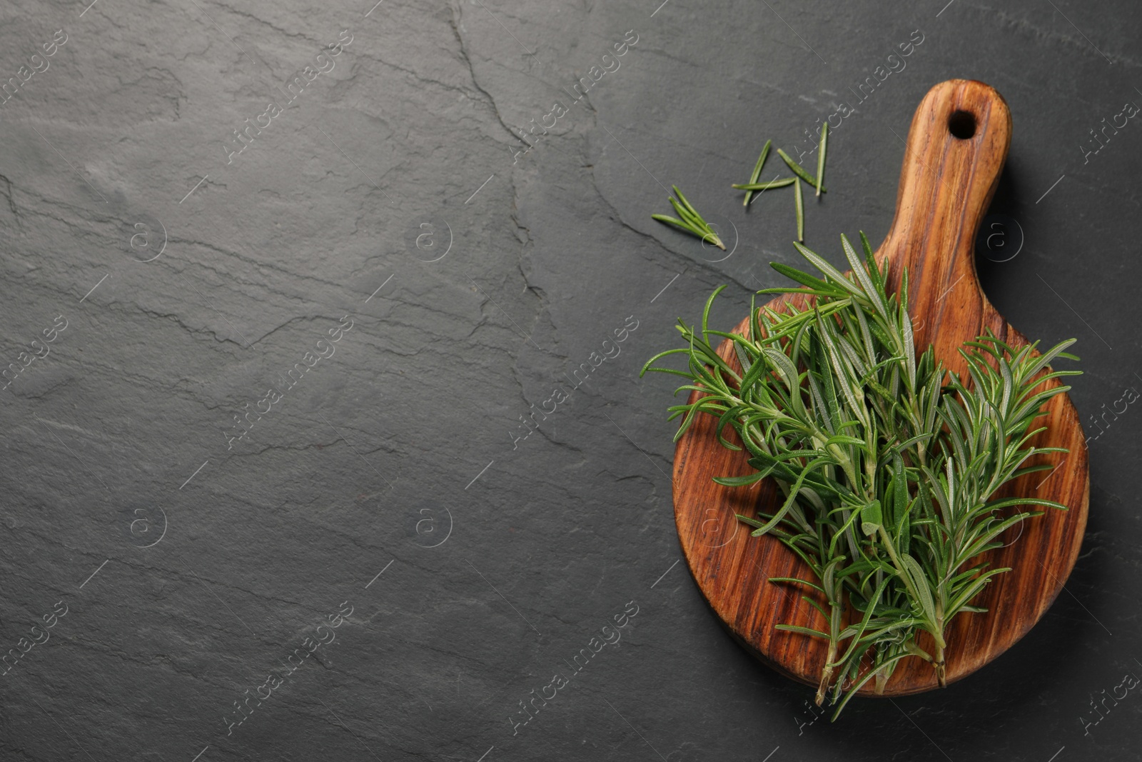Photo of Fresh green rosemary on grey table, top view. Space for text