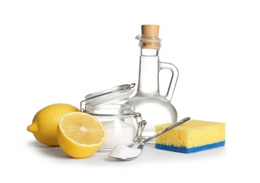 Photo of Composition with vinegar, lemons and baking soda on white background. House cleaning