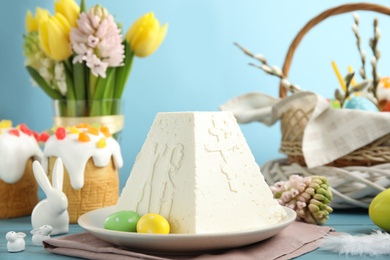 Photo of Traditional cottage cheese Easter paskha on light blue wooden table